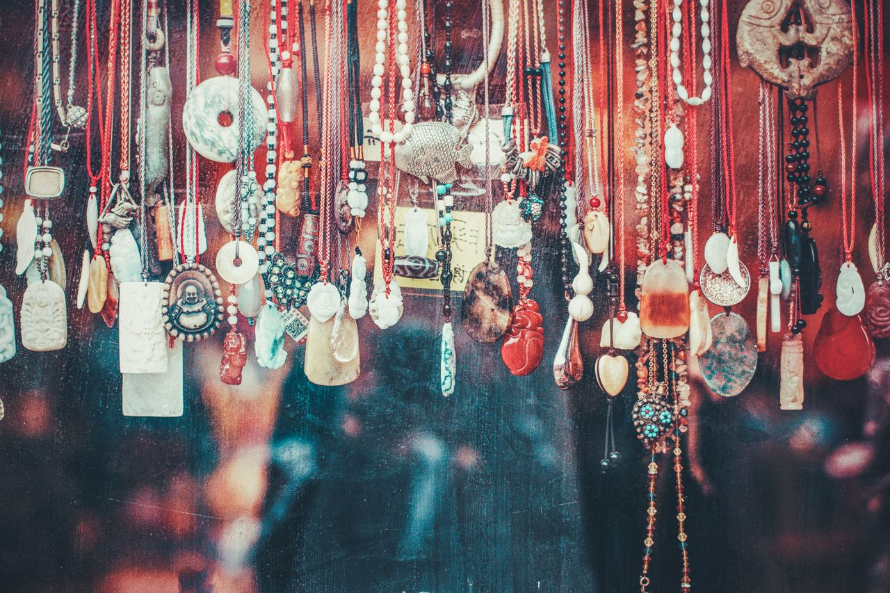 About Vibrant collection of various pendants hanging in a Beijing market. A display of cultural and artistic jewelry.