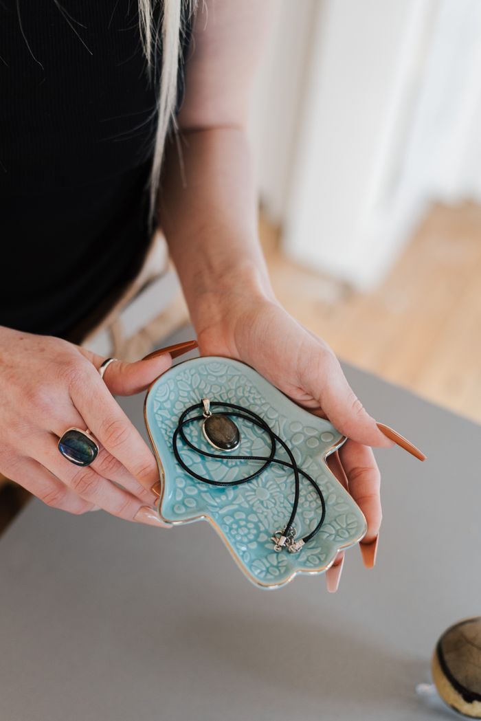 The Art of Drawing Readers In: Your attractive post title goes here From above of crop anonymous female with hamsa plate and amulet in hands on blurred background