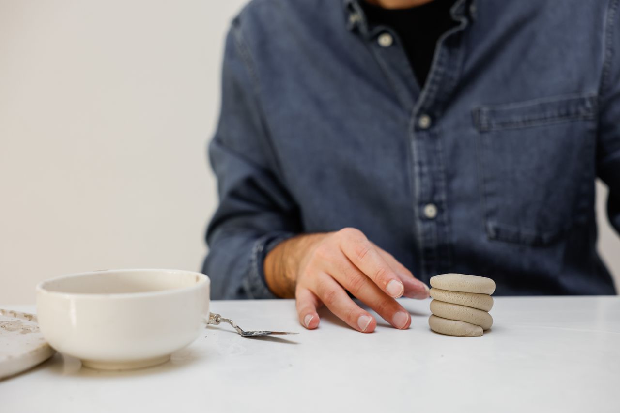Mastering the First Impression: Your intriguing post title goes here Handcrafting ceramic designs in a stylish workspace, showcasing creativity and artistry.